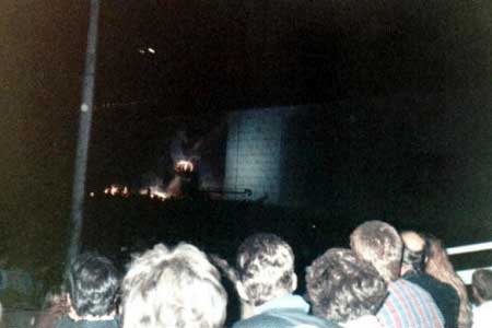 Taken during "The Trial," you can see Albert Finney at center stage on a raised platform playing the Judge. Also at this point The Wall itself became a giant movie screen, with the Gerald Scarfe animation from "The Wall" movie playing on both sides of center stage. What was truly amazing about this (Tom said it doesn't really come across in the pics) was the stunning clarity of all the images projected onto the Wall through out the evening. They were brilliantly lit, and crystal clear.