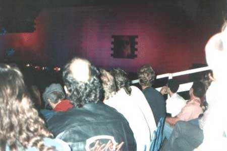 If you look closely, you can see a close up of Roger on the video screen built into the Wall. Each side of the wall had this screen, and there was a huge video screen set up at about halfway back in the field so that the crowd in the back could see. This particular shot of Roger was during "One of My Turns" when he was seating in a "hotel room" set built into the upper left side of The Wall. He was at least a good four stories up!