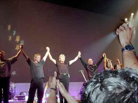 Check out this almost evangelical picture! The light seems to be emanating from the upraised hand and shining on Roger!